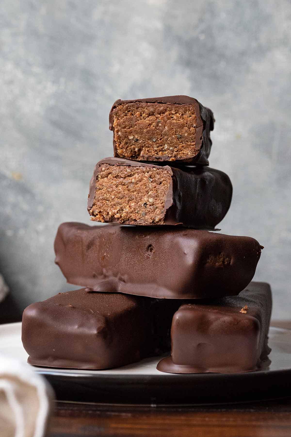 Healthy protein bars with peanut butter and chocolate on a plate.