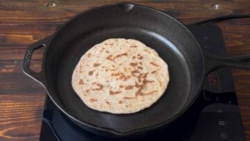A flatbread on a cast iron pan.
