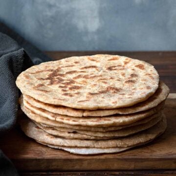 Greek yogurt flatbread on a wooden board.