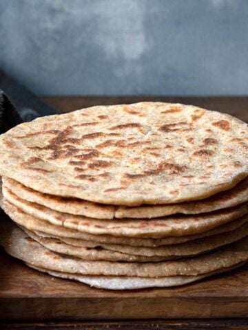 Greek yogurt flatbread on a wooden board.