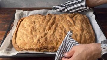Baked Greek cheese pie (tiropita) on a sheet pan.